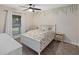 Bright bedroom with floral bedding, side table, white furniture, neutral walls and carpet at 502 W Port Royale Ln, Phoenix, AZ 85023