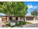 Charming home exterior with a covered patio, green lawn, and well-maintained landscaping at 502 W Port Royale Ln, Phoenix, AZ 85023