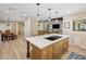 Bright kitchen island with quartz countertops, custom wood cabinetry, and modern cooktop at 502 W Port Royale Ln, Phoenix, AZ 85023