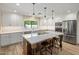 Well-appointed kitchen featuring an island with seating and stainless steel appliances at 502 W Port Royale Ln, Phoenix, AZ 85023