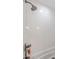 Shower with subway tile and a chrome shower head and handle at 502 W Port Royale Ln, Phoenix, AZ 85023