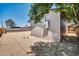 Wide backyard with gravel landscape, featuring a utility box on the home exterior and a shaded tree in the corner at 5236 S 19Th Ave, Phoenix, AZ 85041