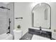 Modern bathroom featuring black fixtures, a rainfall showerhead, and stylish finishes at 5236 S 19Th Ave, Phoenix, AZ 85041
