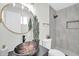 Modern bathroom featuring a vessel sink, stylish tiling, and updated fixtures at 5236 S 19Th Ave, Phoenix, AZ 85041