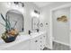 Modern bathroom with dual sinks, arched mirrors, and elegant black fixtures at 5236 S 19Th Ave, Phoenix, AZ 85041