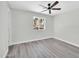 Neutral bedroom with wood-look flooring, ceiling fan, and an exterior window at 5236 S 19Th Ave, Phoenix, AZ 85041