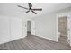 Bright bedroom featuring vinyl floors, an updated closet, and adjacent bathroom at 5236 S 19Th Ave, Phoenix, AZ 85041