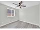 Neutral bedroom featuring wood-look flooring, ceiling fan, and bright natural light at 5236 S 19Th Ave, Phoenix, AZ 85041
