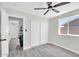 Bright bedroom featuring a ceiling fan, closet with bi-fold doors, and a window at 5236 S 19Th Ave, Phoenix, AZ 85041