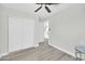 Bright bedroom with neutral walls, hardwood floors, ceiling fan, and closet providing a cozy and serene retreat at 5236 S 19Th Ave, Phoenix, AZ 85041