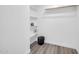 Bright walk-in closet featuring built-in shelving, a hanging rod, and stylish decor at 5236 S 19Th Ave, Phoenix, AZ 85041