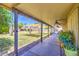 Outdoor patio featuring shade canopies, greenery, and a pathway leading to a serene backyard oasis at 5424 E Florian Ave, Mesa, AZ 85206