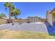 Backyard featuring a gravel area with a shed and bench, surrounded by mature trees at 5424 E Florian Ave, Mesa, AZ 85206