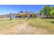 Expansive backyard features large lawn with mature trees and a covered patio area, perfect for entertaining at 5424 E Florian Ave, Mesa, AZ 85206