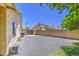 Spacious backyard featuring a gravel landscape, a tall brick fence and beautiful blue skies at 5424 E Florian Ave, Mesa, AZ 85206
