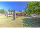 Spacious backyard featuring a covered patio, lush lawn, shade, and a charming outdoor seating area at 5424 E Florian Ave, Mesa, AZ 85206