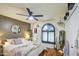 Well-lit bedroom featuring a unique arched window with shelving and decorative plants for added charm at 5424 E Florian Ave, Mesa, AZ 85206