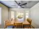 Bright dining room featuring metal ceiling, modern ceiling fan, and view to backyard at 5424 E Florian Ave, Mesa, AZ 85206