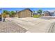 Long driveway and a two-car garage. Gravel front yard with small shrubs adding to its exterior appeal at 5424 E Florian Ave, Mesa, AZ 85206