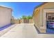 Wide concrete driveway leading to a garage, surrounded by fencing and a gravel-covered yard at 5424 E Florian Ave, Mesa, AZ 85206