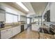 Modern kitchen with granite counters, stainless appliances, white cabinets, and view to dining area at 5424 E Florian Ave, Mesa, AZ 85206