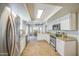 Updated kitchen features granite countertops, white cabinets, and stainless steel appliances at 5424 E Florian Ave, Mesa, AZ 85206
