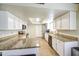 Bright kitchen features white cabinets, granite countertops, stainless appliances, and tile floors at 5424 E Florian Ave, Mesa, AZ 85206