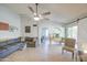 Bright living room with vaulted ceilings, ceiling fan, sliding barn door, and tile floors at 5424 E Florian Ave, Mesa, AZ 85206
