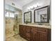 Bathroom features a dual sink vanity, granite countertop, and a tiled walk-in shower at 5424 E Florian Ave, Mesa, AZ 85206