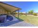 Covered patio featuring comfortable seating and a view of the lush backyard at 5424 E Florian Ave, Mesa, AZ 85206