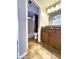 Well-lit bathroom featuring tile flooring, a shower with a curtain, and a vanity with decorative backsplash at 5749 S 247Th Dr, Buckeye, AZ 85326