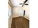 Neutral bedroom featuring a ceiling fan, wood laminate flooring, and a closet with double doors at 5749 S 247Th Dr, Buckeye, AZ 85326