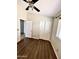 Simple bedroom with dark wood laminate flooring, a ceiling fan, and a double door closet at 5749 S 247Th Dr, Buckeye, AZ 85326