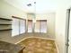 Bright breakfast nook area with two large windows, a modern light fixture, and easy access to kitchen at 5749 S 247Th Dr, Buckeye, AZ 85326