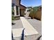 Well maintained front yard featuring a desert landscape, a mature palm tree, and a walkway to the front door at 5749 S 247Th Dr, Buckeye, AZ 85326