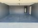 Clean, painted garage featuring an epoxy floor and built-in water heater niche at 5749 S 247Th Dr, Buckeye, AZ 85326