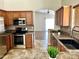 Stylish kitchen with stainless steel appliances, tile backsplash, and an open design for easy entertaining at 5749 S 247Th Dr, Buckeye, AZ 85326