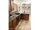 Well equipped kitchen with a breakfast bar, stainless steel dishwasher, and natural light from the window at 5749 S 247Th Dr, Buckeye, AZ 85326