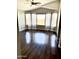 Bright living room showcasing hardwood floors, vaulted ceiling, and abundant natural light at 5749 S 247Th Dr, Buckeye, AZ 85326