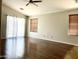 Bright living room with hardwood floors, ceiling fan, and window coverings for added privacy at 5749 S 247Th Dr, Buckeye, AZ 85326