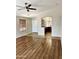 Open-concept living room showcasing hardwood floors and an archway leading to the kitchen at 5749 S 247Th Dr, Buckeye, AZ 85326