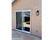 View of a sliding glass door and patio with stone tiling at 5749 S 247Th Dr, Buckeye, AZ 85326
