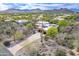 Aerial view of a desert home with solar panels, landscaping, and picturesque mountain views at 5892 E Carefree Mountain Dr, Carefree, AZ 85377