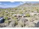 An aerial view of the property, surrounded by the desert landscape and mountains at 5892 E Carefree Mountain Dr, Carefree, AZ 85377