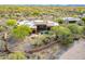 Stunning aerial view of a modern home featuring a private pool and lush desert landscaping at 5892 E Carefree Mountain Dr, Carefree, AZ 85377
