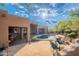Expansive backyard with a pool, desert landscaping, and inviting patio areas for outdoor enjoyment at 5892 E Carefree Mountain Dr, Carefree, AZ 85377