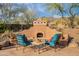 A cozy outdoor seating area with a fireplace offers relaxation and desert ambiance at 5892 E Carefree Mountain Dr, Carefree, AZ 85377