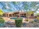 A peaceful backyard features desert landscaping, a refreshing pool, and outdoor seating for relaxation at 5892 E Carefree Mountain Dr, Carefree, AZ 85377