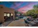 Beautiful backyard with pool, patio, lush landscaping, and open living spaces at 5892 E Carefree Mountain Dr, Carefree, AZ 85377