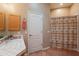 A well-lit bathroom featuring a shower with curtain and tiled flooring at 5892 E Carefree Mountain Dr, Carefree, AZ 85377